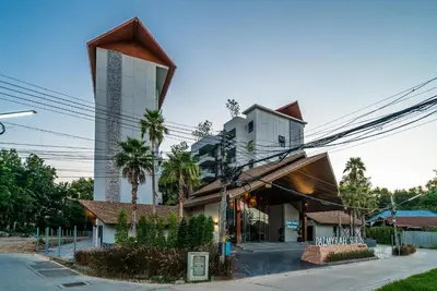 a building with a curvilinear facade on a street at Apartment at Palmyrah Surin by Lofty in Surin Beach