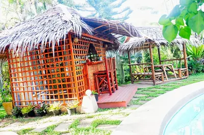 a small hut with a thatched roof at Kingsacre in Nai Yang Beach