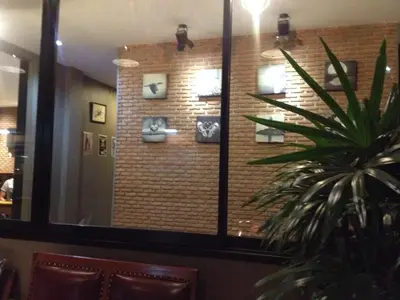 a mirror in a restaurant with a brick wall at Dfeel House in Patong Beach