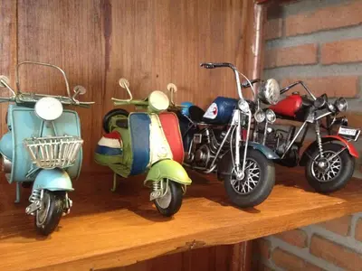 three motor scooters are sitting on a wooden shelf at Dfeel House in Patong Beach