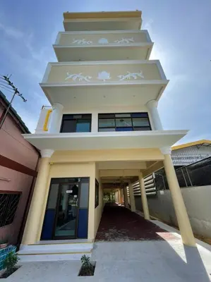 a building with a tower on top of it at บ้านบัว เมืองใหม่ Baanbua Muangmai in Thalang