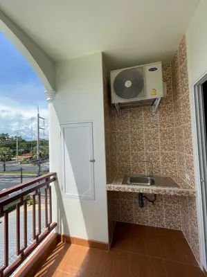 a kitchen with a sink and a balcony at บ้านบัว เมืองใหม่ Baanbua Muangmai in Thalang
