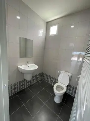 a bathroom with a toilet and a sink at บ้านบัว เมืองใหม่ Baanbua Muangmai in Thalang