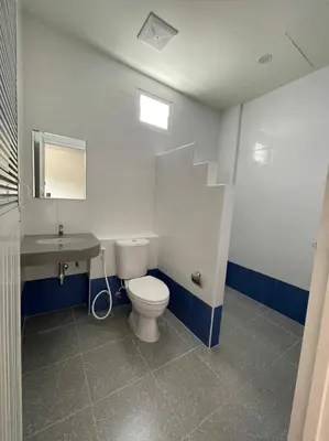 a bathroom with a toilet and a sink at บ้านบัว เมืองใหม่ Baanbua Muangmai in Thalang