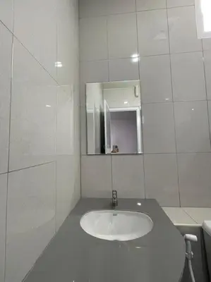 a white bathroom with a sink and a mirror at บ้านบัว เมืองใหม่ Baanbua Muangmai in Thalang