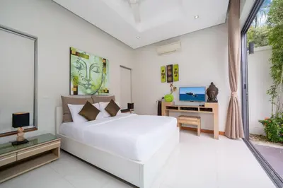 a white bedroom with a white bed and a desk at Relax & Enjoy Stay! Elegant 3BR Pool Villa Talosy in Rawai Beach