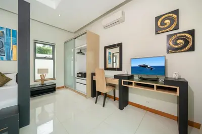 a home office with a desk and a television at Relax & Enjoy Stay! Elegant 3BR Pool Villa Talosy in Rawai Beach