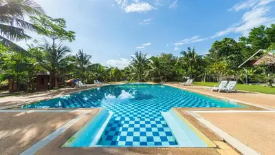 a swimming pool with a checkeredkeredkeredkered at Doo Dee Boutique Resort by Swiss Chalet in Ao Nang Beach