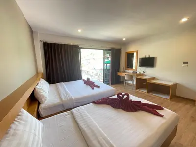 a hotel room with two beds with bows on them at Room Actually Service Apartment in Karon Beach