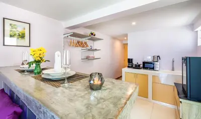 a kitchen with a counter top in a room at Mango Tree Villa in Panwa Beach