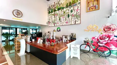 a coffee shop with a red bike on the counter at Tour De Phuket Hotel - SHA Plus in Thalang