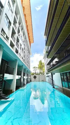a large swimming pool in the middle of a building at Tour De Phuket Hotel - SHA Plus in Thalang