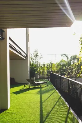 a patio with a bench on the side of a house at Tour De Phuket Hotel - SHA Plus in Thalang