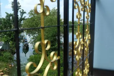 a window with a view of a boat in the water at Tubkaek mansion in Tab Kaek Beach