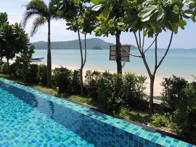 a swimming pool with a view of the beach at Davina Beach Homes in Panwa Beach