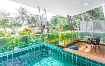 a balcony with a swimming pool and a table at Davina Beach Homes in Panwa Beach