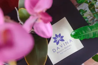 a pink flower with a card next to a plant at Davina Beach Homes in Panwa Beach