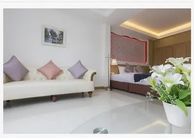 a living room with a couch and a bed at Lucky Sun Patong in Patong Beach