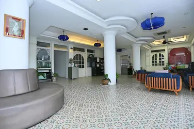 a lobby with a couch and chairs in a building at Lucky Sun Patong in Patong Beach