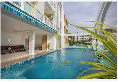 a swimming pool in the middle of a building at Lucky Sun Patong in Patong Beach