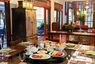 a table with plates of food on top of it at Villa Salika in Rawai Beach