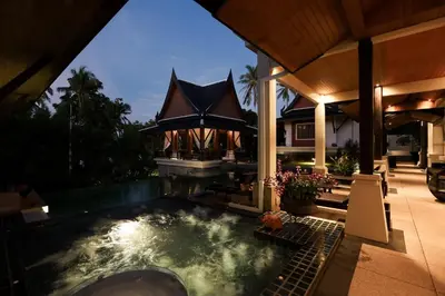 a house with a swimming pool in the backyard at Villa Salika in Rawai Beach