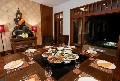 a table with plates of food on top of it at Villa Salika in Rawai Beach