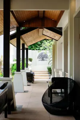 a lobby with chairs and a staircase in a building at Villa Salika in Rawai Beach