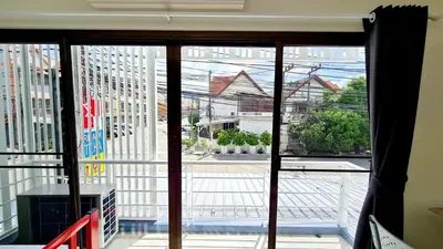 a view of a street from a glass window at TP House@Naka in Phuket Town