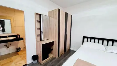 a bedroom with a bed and a mirror and a sink at TP House@Naka in Phuket Town