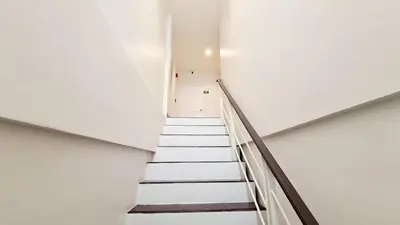 a staircase in a building with white walls at TP House@Naka in Phuket Town