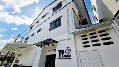 a white building with a sign on it at TP House@Naka in Phuket Town