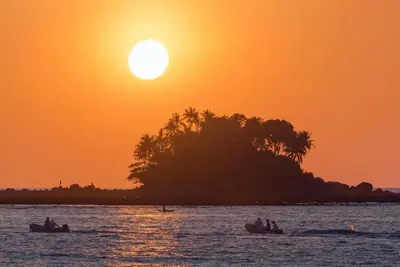 people in boats in the water at sunset at Ideo Phuket Hotel - Naiyang Beach in Nai Yang Beach
