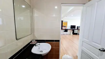 a bathroom with a sink and a glass shower at TP House at town in Phuket Town