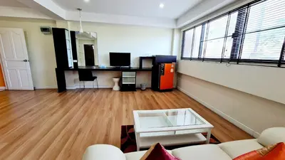 a living room with a white couch and a desk at TP House at town in Phuket Town