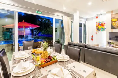 a dining room with a table with a bowl of fruit at 3 Bedroom Exclusive Private Pool Villa Smooth as Silk in Ao Nang Beach