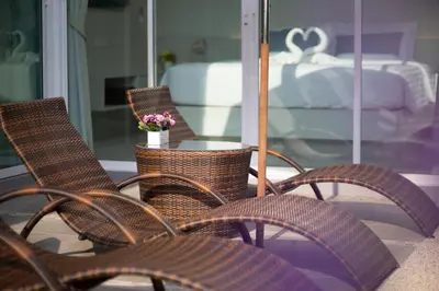a group of wicker chairs and a table with flowers at 3 Bedroom Exclusive Private Pool Villa Smooth as Silk in Ao Nang Beach