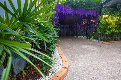 a garden with purple flowers on a fence at 3 Bedroom Exclusive Private Pool Villa Smooth as Silk in Ao Nang Beach