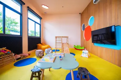 a childs play room with a table and toys at HOMA Phuket Town in Phuket Town