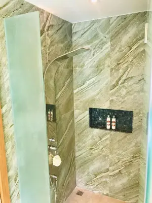 a bathroom with a shower with a stone wall at Villa MAI MEE PAN HA 3 bedrooms in Nai Yang Beach