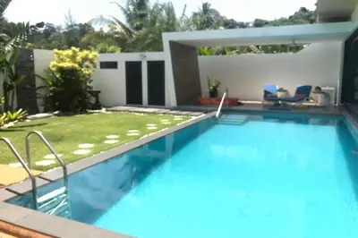 a swimming pool in the backyard of a house at Villa MAI MEE PAN HA 3 bedrooms in Nai Yang Beach