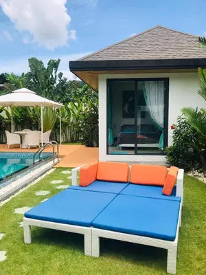 a blue and orange couch in front of a house at Villa MAI MEE PAN HA 3 bedrooms in Nai Yang Beach