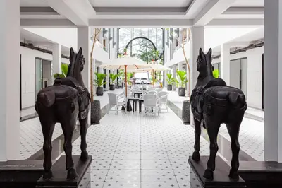 two statues of horses on display in a building at Anona Beachfront Phuket Resort-SHA EXTRA PLUS in Patong Beach
