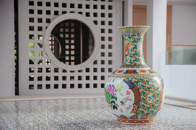 a colorful vase sitting on a table in a room at Anona Beachfront Phuket Resort-SHA EXTRA PLUS in Patong Beach
