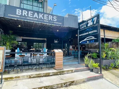 a restaurant with tables and chairs in front of it at Breakers Hotel Rawai in Rawai Beach