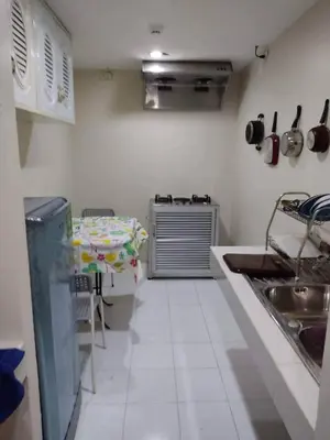 a kitchen with a sink and a table in it at Studio apartments on a hill in Kathu