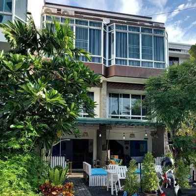 a building with a table and chairs in front of it at Baan Oui guest house - Nai Harn in Phuket Town