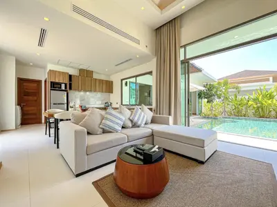 a living room with a couch and a table at SHAMBHALA GRAND Pool Villas x MonthStayZ Thailand in Phuket Town