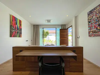 a room with a desk with a view of the ocean at SHAMBHALA GRAND Pool Villas x MonthStayZ Thailand in Phuket Town