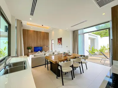 a kitchen and dining room with a table and chairs at SHAMBHALA GRAND Pool Villas x MonthStayZ Thailand in Phuket Town